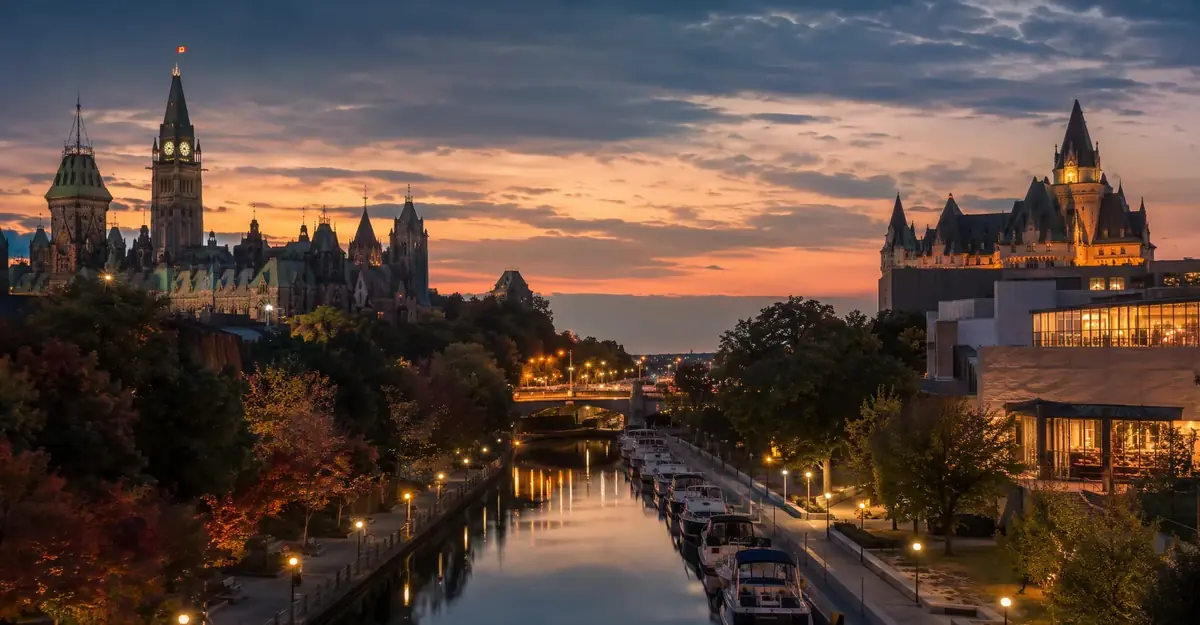 Panoramic evening view of the Rideau Canal and Parliament Hill in warm dusk light
